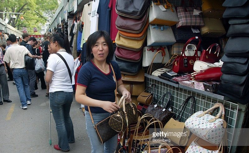 Vendor arranges fake Louis Vuitton handbags.jpg